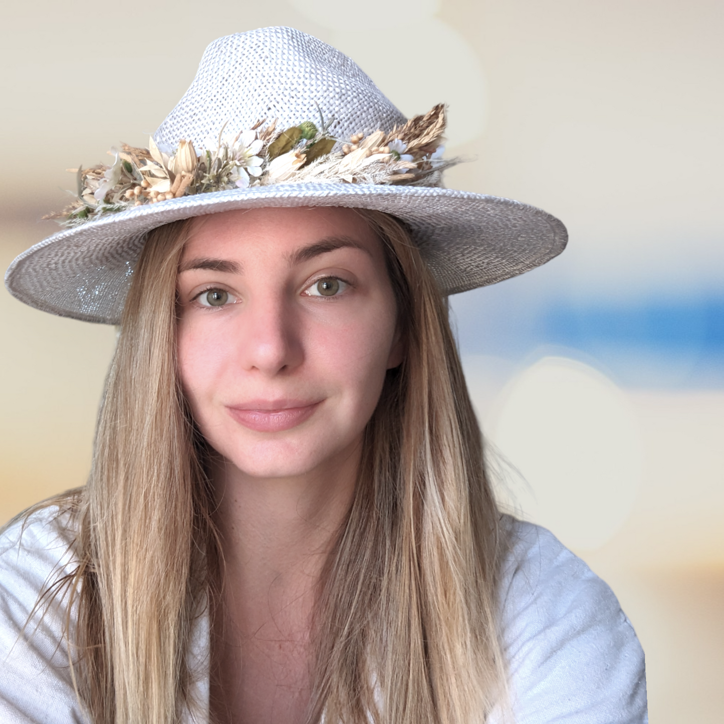 Girl wearing White straw hat with dried flower band