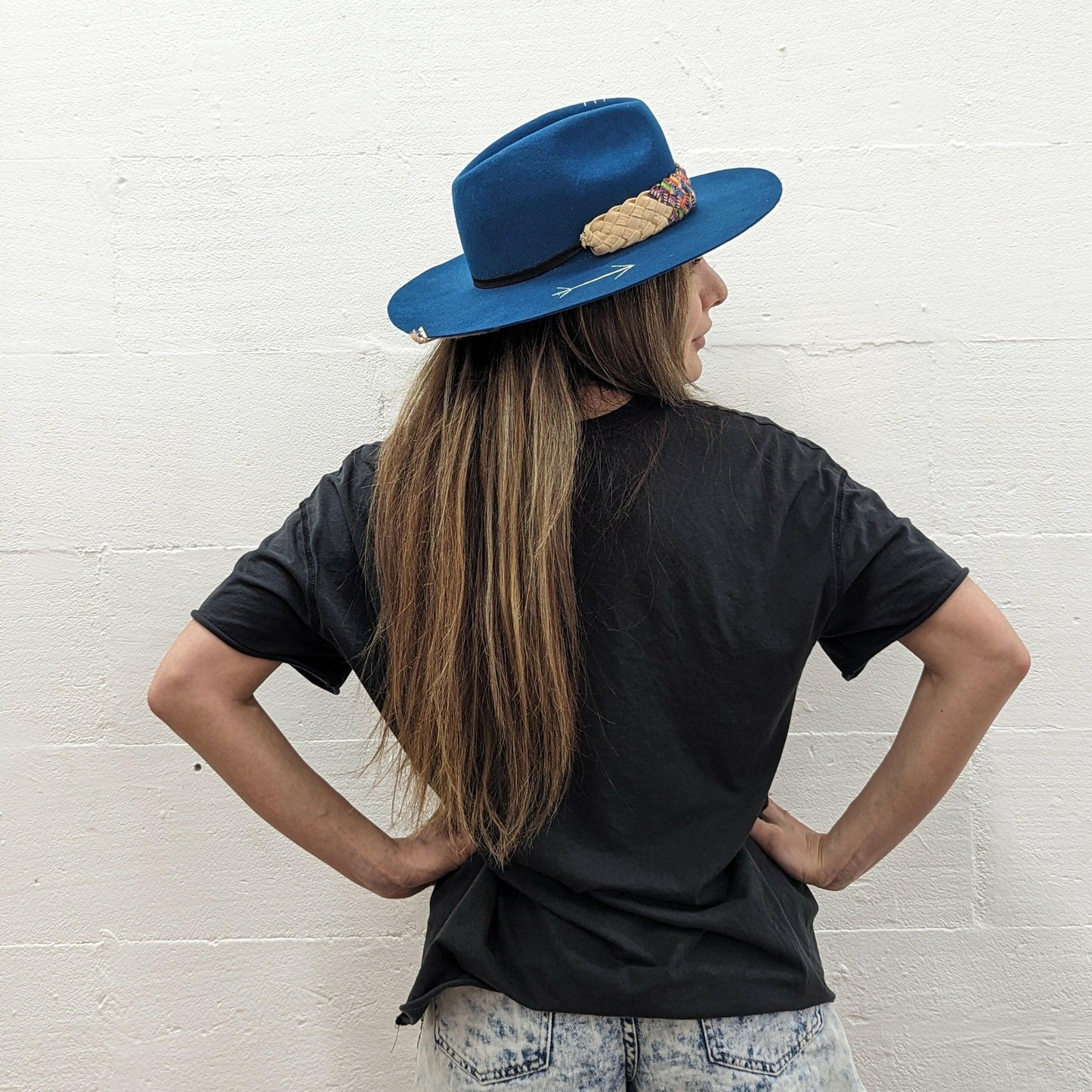 Model wearing blue fedora hat